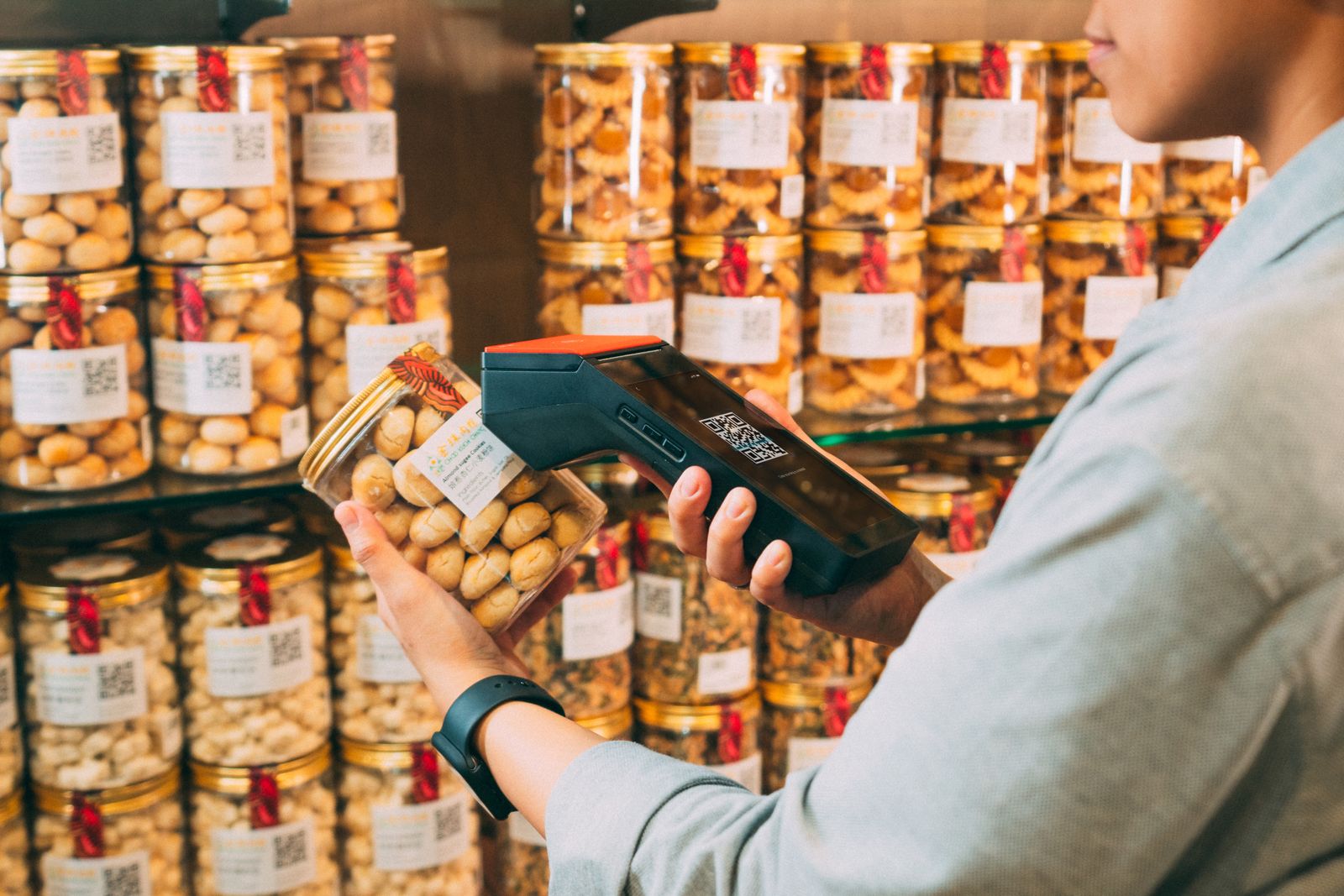 Stock photograph of a handheld scanner reading a packaged food jar label